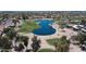 Stunning aerial view of community with lush golf course and serene lake at 16083 W Cambridge Ave, Goodyear, AZ 85395