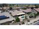 Aerial view featuring a backyard pool, landscaped yard, and solar panels on nearby roofs at 16083 W Cambridge Ave, Goodyear, AZ 85395