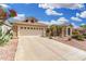 A charming home featuring a two-car garage, desert landscaping, and a covered entrance, enhancing its curb appeal at 16083 W Cambridge Ave, Goodyear, AZ 85395