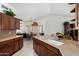 A well-appointed kitchen that features an island with a sink and counter seating, and views of the dining area at 16083 W Cambridge Ave, Goodyear, AZ 85395