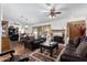 An open-concept living room area that features a fireplace, leather furniture, and a dining area at 16083 W Cambridge Ave, Goodyear, AZ 85395