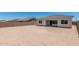 Spacious backyard enclosed with a brick wall and a covered patio, offering privacy and room to customize at 16494 W Creedance Blvd, Surprise, AZ 85387