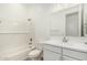 Bright bathroom with a shower-tub combo, white subway tile, and a vanity with generous counter space at 16494 W Creedance Blvd, Surprise, AZ 85387