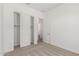 Bright bedroom featuring neutral carpet, closet with sliding doors, and an open doorway at 16494 W Creedance Blvd, Surprise, AZ 85387