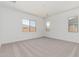 Spacious bedroom with plush carpeting, lots of natural light from the windows at 16494 W Creedance Blvd, Surprise, AZ 85387