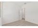 An airy bedroom featuring neutral carpet, white walls, and an open doorway at 16494 W Creedance Blvd, Surprise, AZ 85387