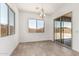 Dining room featuring a modern chandelier, large windows, and sliding glass door at 16494 W Creedance Blvd, Surprise, AZ 85387