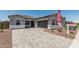 Charming single-story home featuring a stone driveway, gray stucco, and a two-car garage at 16494 W Creedance Blvd, Surprise, AZ 85387