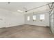 Clean, spacious garage with sealed concrete floors, three windows, and an automatic garage door at 16494 W Creedance Blvd, Surprise, AZ 85387