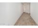 Bright hallway with wood-look tile and doors at 16494 W Creedance Blvd, Surprise, AZ 85387