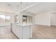 Modern kitchen features a large island, stainless steel appliances, and an open floor plan at 16494 W Creedance Blvd, Surprise, AZ 85387