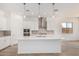 Open kitchen featuring white cabinets, stainless appliances, a large island, and modern lighting at 16494 W Creedance Blvd, Surprise, AZ 85387