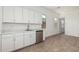 Bright kitchenette with white cabinets, stainless steel appliances, and tile floor at 16494 W Creedance Blvd, Surprise, AZ 85387