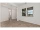 Open-concept living room with tiled floors, large windows, and a bright, airy feel at 16494 W Creedance Blvd, Surprise, AZ 85387