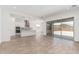 Open-concept living space with kitchen, living area, and sliding glass doors to backyard at 16494 W Creedance Blvd, Surprise, AZ 85387
