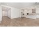 Spacious living room featuring an open floor plan and light wood-look flooring at 16494 W Creedance Blvd, Surprise, AZ 85387