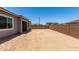 Spacious backyard with a block fence, ample space for outdoor activities, and potential for landscaping at 16550 W Creedance Blvd, Surprise, AZ 85387
