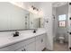 Bright bathroom with double sinks, modern lighting, and a separate toilet area at 16550 W Creedance Blvd, Surprise, AZ 85387