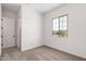 Cozy bedroom with neutral walls, carpet, and a large window at 16550 W Creedance Blvd, Surprise, AZ 85387