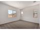 Bedroom with plush carpet, neutral walls, and multiple windows providing ample natural light at 16550 W Creedance Blvd, Surprise, AZ 85387