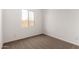 A bedroom with neutral walls, carpet, and a window that lets in natural light at 16550 W Creedance Blvd, Surprise, AZ 85387
