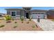 Charming single-story home featuring stone accents and a well-maintained front yard at 16550 W Creedance Blvd, Surprise, AZ 85387