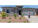 Charming single-story home with well-manicured landscaping and inviting front entrance at 16550 W Creedance Blvd, Surprise, AZ 85387