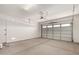 Spacious two car garage featuring concrete floor and white door at 16550 W Creedance Blvd, Surprise, AZ 85387