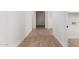 Clean hallway showcasing the wood-look tile flooring throughout the home at 16550 W Creedance Blvd, Surprise, AZ 85387