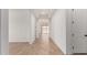 Long hallway with tile floors and white walls leads to other rooms in the home at 16550 W Creedance Blvd, Surprise, AZ 85387