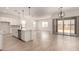 Bright open kitchen flows to spacious living area with sliding glass door at 16550 W Creedance Blvd, Surprise, AZ 85387