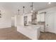 Open-concept kitchen with island seating and stainless steel appliances at 16550 W Creedance Blvd, Surprise, AZ 85387