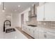 Contemporary kitchen featuring a gas cooktop, white cabinetry, and quartz countertops at 16550 W Creedance Blvd, Surprise, AZ 85387