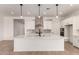 Bright, open kitchen with white cabinets, quartz countertops, and stainless steel appliances at 16550 W Creedance Blvd, Surprise, AZ 85387