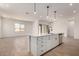 Island featuring stainless steel dishwasher and single basin sink with modern faucet and pendant lights overhead at 16550 W Creedance Blvd, Surprise, AZ 85387