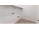 Bright laundry room with white walls, tile flooring and hookups at 16550 W Creedance Blvd, Surprise, AZ 85387
