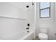 Bright and modern shower and toilet with window and black fixtures at 16550 W Creedance Blvd, Surprise, AZ 85387