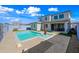 Inviting backyard with a refreshing pool, gravel landscaping, and a covered patio area at 16840 W Monroe St, Goodyear, AZ 85338