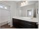 Stylish bathroom features a modern vanity and a shower-tub combination at 16840 W Monroe St, Goodyear, AZ 85338