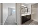 Bathroom showcasing a double vanity, walk-in shower, and ample space, combining style and functionality at 16840 W Monroe St, Goodyear, AZ 85338