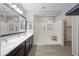 Bright bathroom with double sinks, large shower, and a clean, modern design at 16840 W Monroe St, Goodyear, AZ 85338