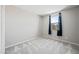 Vacant bedroom features soft carpeting, one window with a scenic view, and neutral gray walls at 16840 W Monroe St, Goodyear, AZ 85338