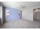 Spacious bedroom filled with natural light features a ceiling fan and neutral carpeting at 16840 W Monroe St, Goodyear, AZ 85338