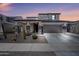 Two-story home featuring desert landscaping, a two-car garage, and a covered porch with stone accents at 16840 W Monroe St, Goodyear, AZ 85338