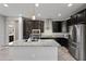 Spacious kitchen with an island, granite countertops, and stainless steel appliances at 16840 W Monroe St, Goodyear, AZ 85338