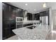 Stylish kitchen featuring granite countertops, stainless steel appliances, and dark cabinetry at 16840 W Monroe St, Goodyear, AZ 85338