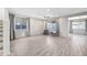 Spacious living room with tile flooring, large windows, and a ceiling fan, perfect for relaxation at 16840 W Monroe St, Goodyear, AZ 85338