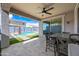 Beautiful outdoor patio with a dining area, an in-ground pool and lush landscaping at 16840 W Monroe St, Goodyear, AZ 85338