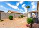 Landscaped backyard with patio, desert plants, and block fence at 16848 W Rimrock St, Surprise, AZ 85388