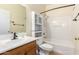 Cozy bathroom featuring a shower-tub combo, vanity, and toilet at 16848 W Rimrock St, Surprise, AZ 85388